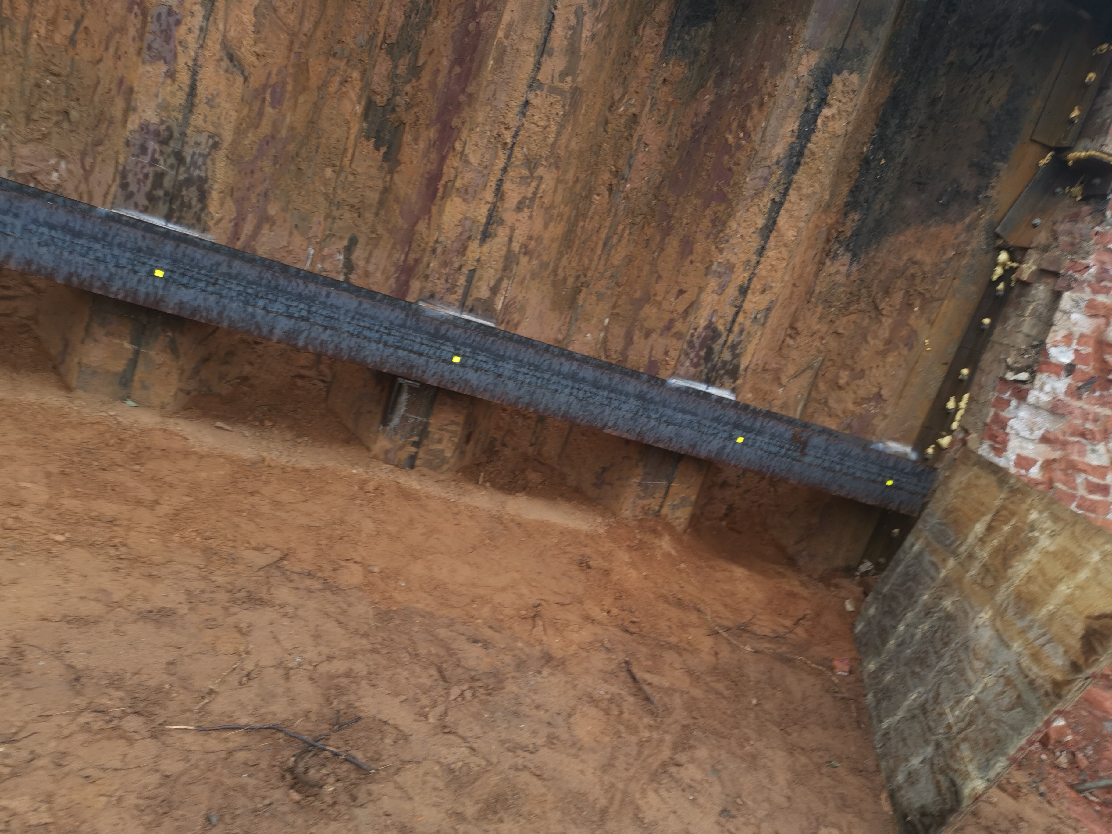 Progress shot showing the braced sheet piles under the live rail