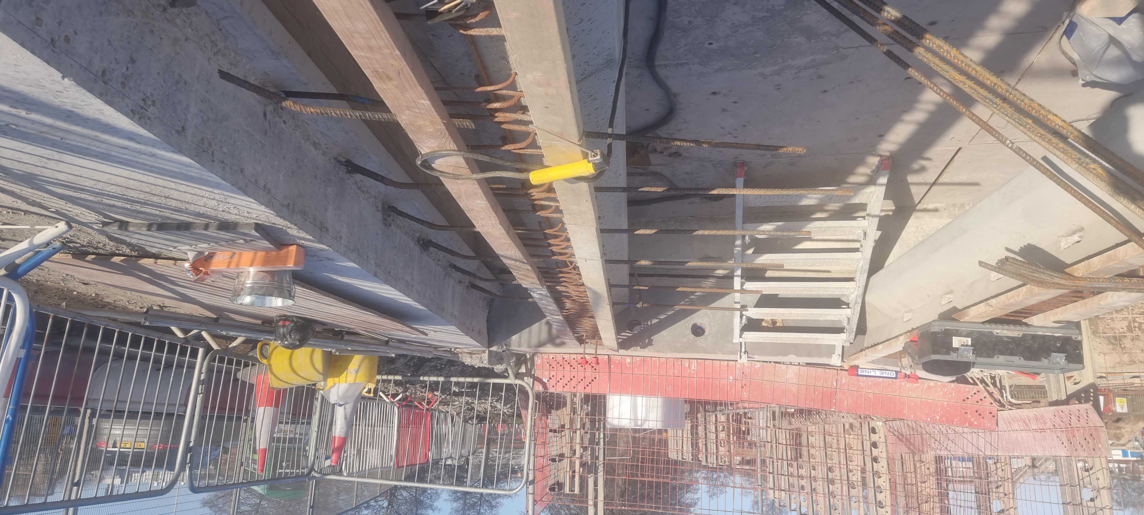 Bridge extension with coded welds tying new rebar into existing reinforcement